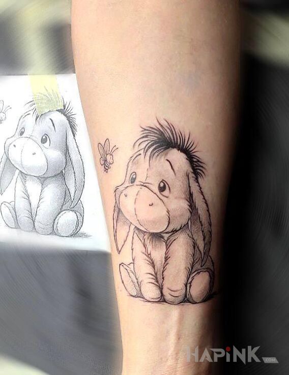 Tattoo Kłapouchy z Kubusia Puchatka in black and gray motif and cartoon / comic book style On the arm