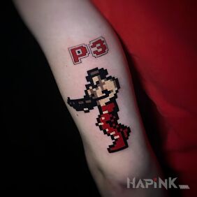 Tattoo Pixel tattoo - Contra on the upper arm motif: colorful style: graphic / illustrative