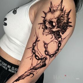 Tattoo Skull with spikes on the upper arm motif: skulls style: realistic