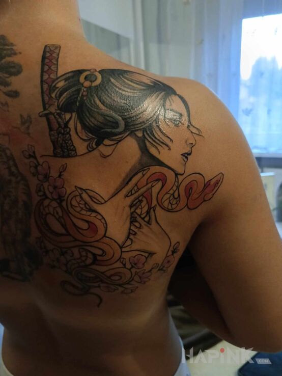 Tattoo Gey in faces motif and japanese / irezumi style on the shoulder blades