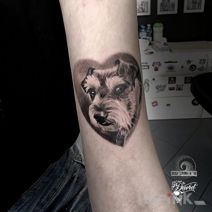 Tattoo Piesek in animals motif and realistic style on the forearm