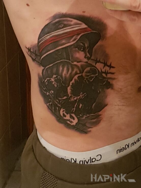 Tattoo POWSTANIE WARSZAWSKIE in patriotic motif on the ribs