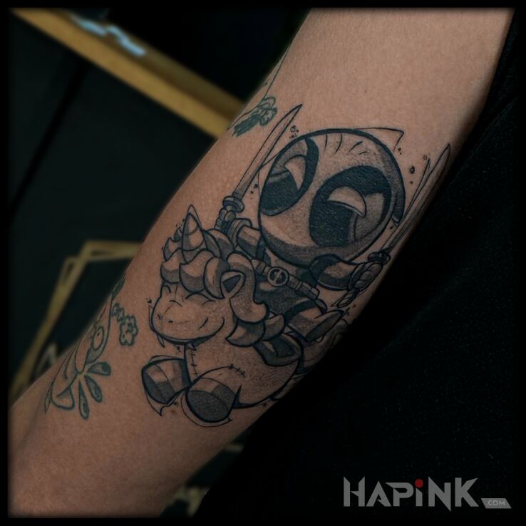 Tattoo Deadpool na jednorożcu in funny motif and graphic / illustrative style On the arm