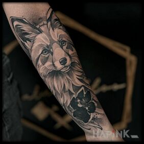 Tattoo Fox and its paw on the forearm motif: black and gray style: dotwork