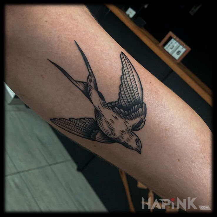 Tattoo Jaskółka in black and gray motif and engravings / gravure style on the forearm