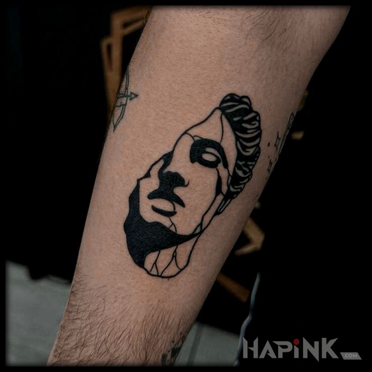 Tattoo Greka in faces motif and graphic / illustrative style On the arm