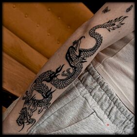 Tattoo Coiling dragon on the forearm motif: dragons style: oldschool