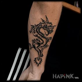 Tattoo Traditional Chinese dragon On the arm motif: black and gray style: oldschool