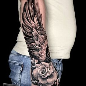 Tattoo Winged rose On the arm motif: wings style: realistic