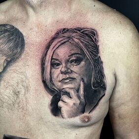Tattoo Portrait of a woman on the chest motif: black and gray style: realistic