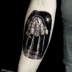 Tattoo Time slipping through fingers on the forearm motif: objects style: realistic