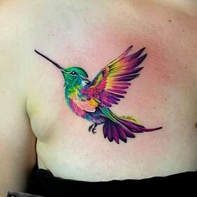 Tattoo MULTICOLORED HUMMINGBIRD on the breast motif: colorful style: realistic