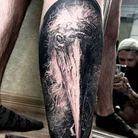 Tattoo PELICAN REALISM on the calf motif: black and gray style: realistic