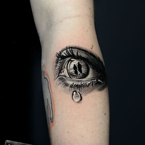 Tattoo FAMILY IN THE EYE on the forearm motif: black and gray style: realistic