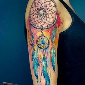 Tattoo COLORFUL DREAMCATCHER On the arm motif: objects style: realistic