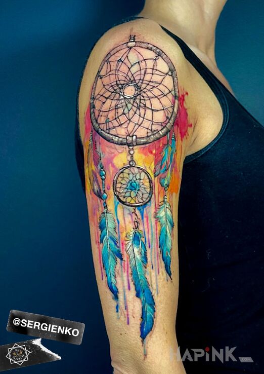 Tattoo COLORFUL DREAMCATCHER in Indian motif and realistic style on the upper arm