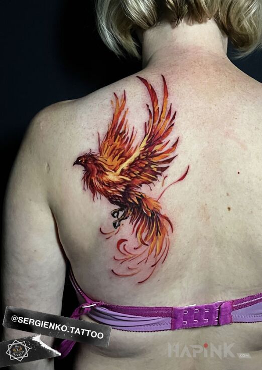 Tattoo FENIKS KOLOR in fantasy motif and realistic style on the shoulder blades