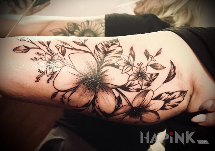 Tattoo Graphic Flowers in floral motif and graphic / illustrative style on the bicep