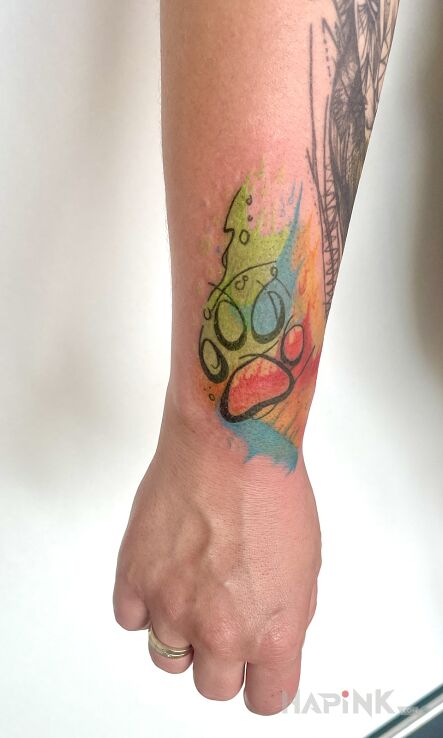 Tattoo DOG PAW in Watercolor style on the forearm