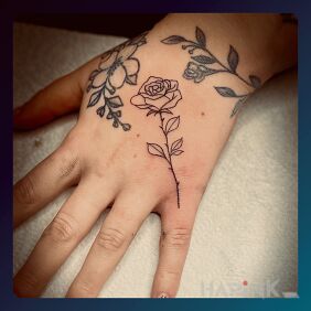 Tattoo OUTLINED ROSE On the arm motif: black and gray style: minimalistic