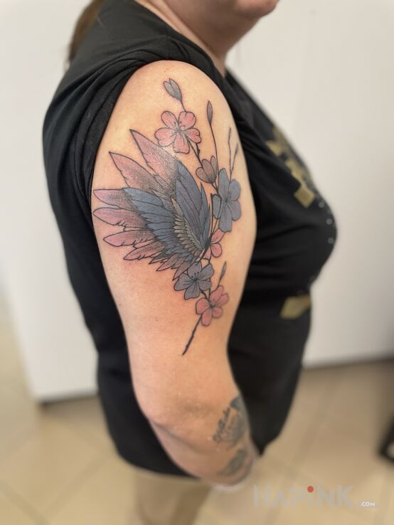 Tattoo BUTTERFLY FLOWER in fantasy motif and graphic / illustrative style On the arm