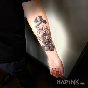 Tattoo SCROOGE MC DUCK on the forearm motif: characters style: graphic / illustrative