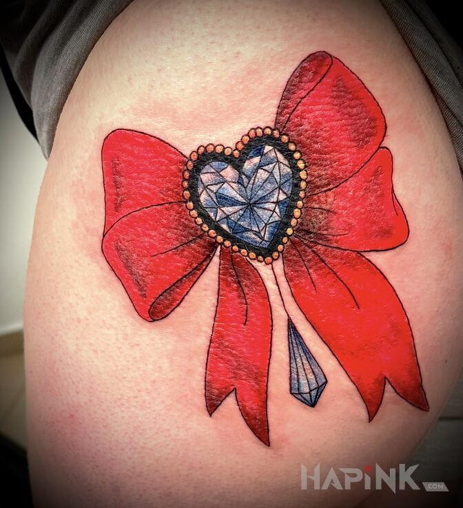 Tattoo COCKADE WITH DIAMOND in colorful motif and graphic / illustrative style on the thigh