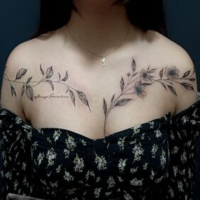 Tattoo FEMININE LEAVES between the breasts motif: flowers style: graphic / illustrative