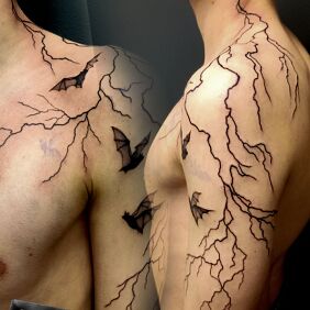 Tattoo LIGHTNING BAT On the arm motif: black and gray style: graphic / illustrative