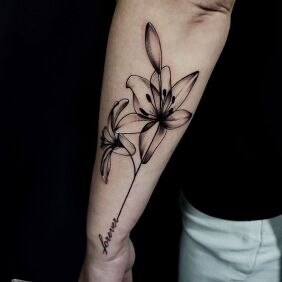 Tattoo LILY INSCRIPTION on the forearm motif: lettering style: graphic / illustrative