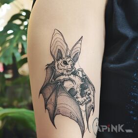 Tattoo Skull in the embrace of a bat on the bicep motif: animals style: graphic / illustrative