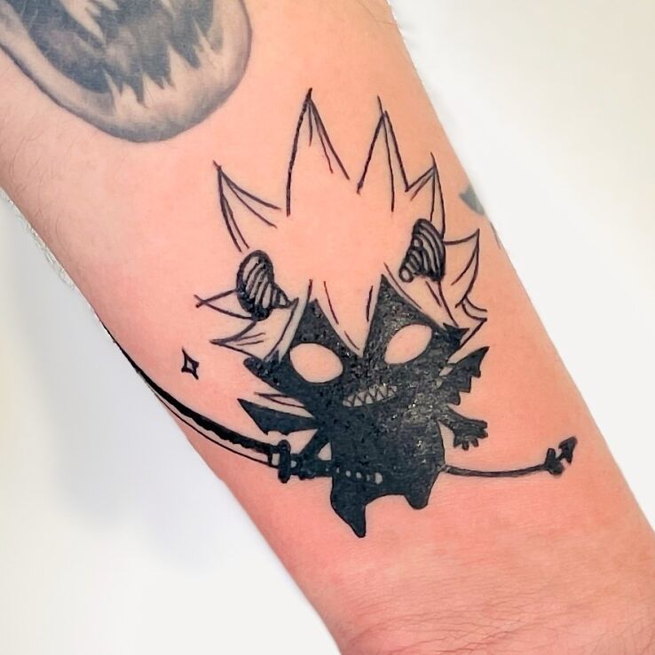Tattoo Diabełek in black and gray motif and blackwork / blackout style On the arm
