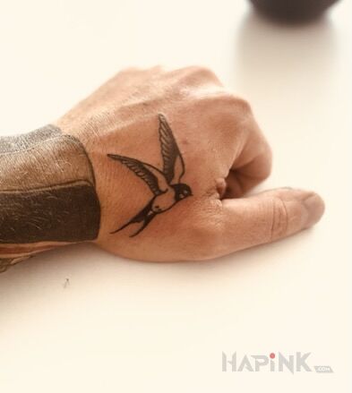 Tattoo Swallow in black and gray motif and oldschool style On the arm