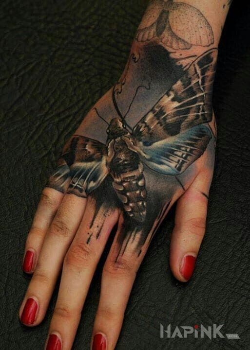 Tattoo Ćma in butterflies motif and realistic style on the hand