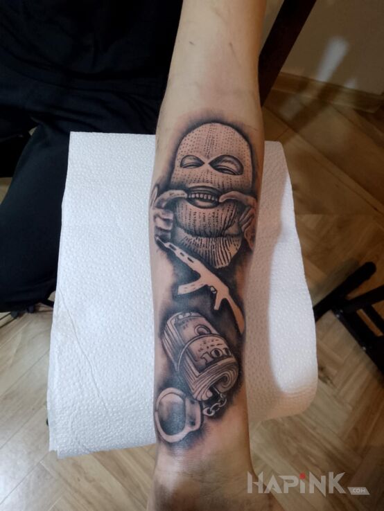 Tattoo Gangsterski in black and gray motif and realistic style On the arm