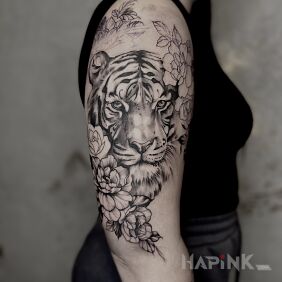 Tattoo Tiger in a floral scenery On the arm motif: animals