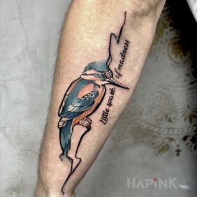 Tattoo Colorful bird On the arm motif: lettering style: graphic / illustrative