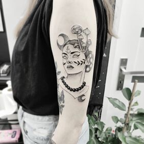 Tattoo Miss Mushroom on the upper arm motif: faces style: graphic / illustrative