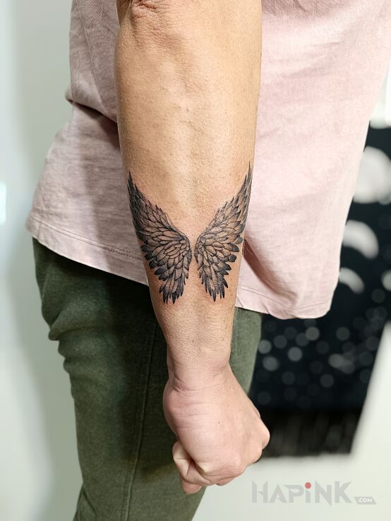 Tattoo Skrzydła in black and gray motif and graphic / illustrative style On the arm