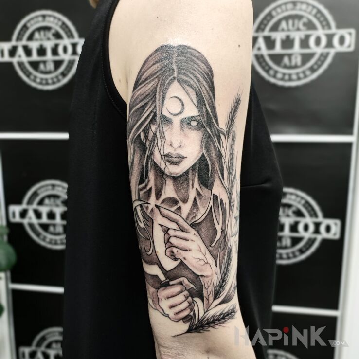 Tattoo Południca in dark motif and graphic / illustrative style On the arm