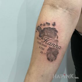 Tattoo Little Foot On the arm motif: lettering style: calligraphy