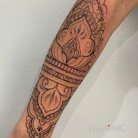 Tattoo Ornamental on the forearm motif: black and gray style: contour / linework