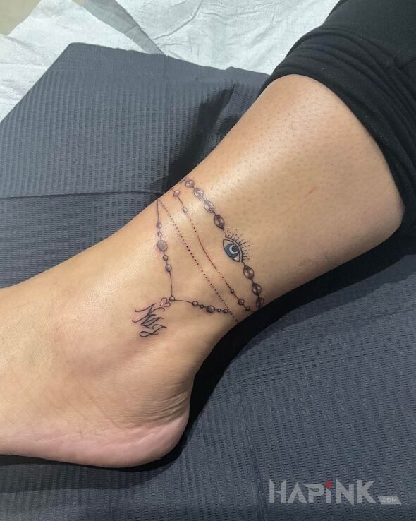 Tattoo Bransoletka na nodze in black and gray motif and minimalistic style on the leg