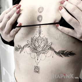Tattoo Lotus flower and chakras underboob motif: black and gray style: graphic / illustrative
