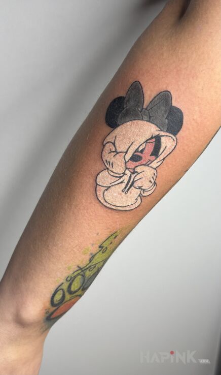 Tattoo Mickey Mouse in a sweater in colorful motif and cartoon / comic book style On the arm