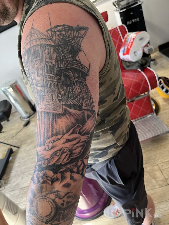 Tattoo Kopalnia KWK Wieczorek in black and gray motif and realistic style On the arm