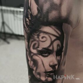 Tattoo Female face on the upper arm motif: black and gray style: realistic