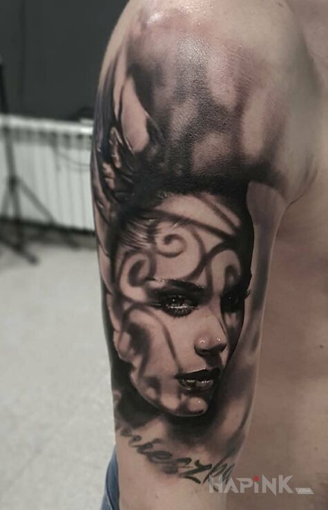 Tattoo Kobieca twarz in black and gray motif and realistic style on the upper arm
