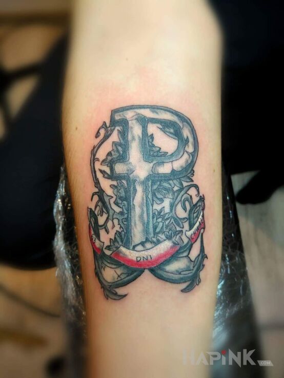 Tattoo Polska Walcząca in patriotic motif on the forearm