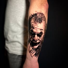 Tattoo JOKER on the forearm motif: faces style: realistic